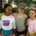 three kids standing next to each other