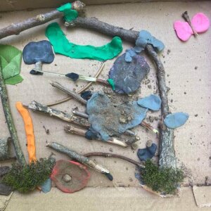 Collaborative clay project #3: Moss and rocks, soil, treasures found outdoors, butterfly