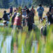 large group of people on the shore of a lake