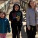 three kids on a dock