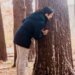 parent playing hide-and-seek with child in forest
