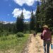 Monica walking with her kids down a path.