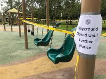 playground with sign that says it's close